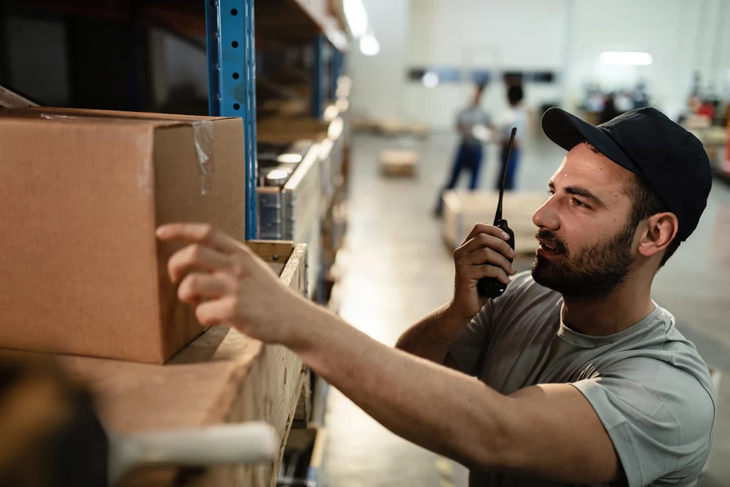 man-inspecting-boxes-with-radio-in-warehouse-2026-03-16-03-29-15-utc 2